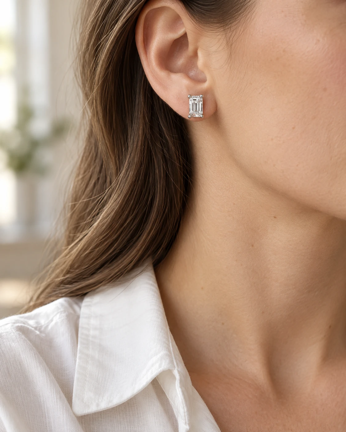 Illustrative close-up of emerald-cut diamond stud earrings, your everyday styling