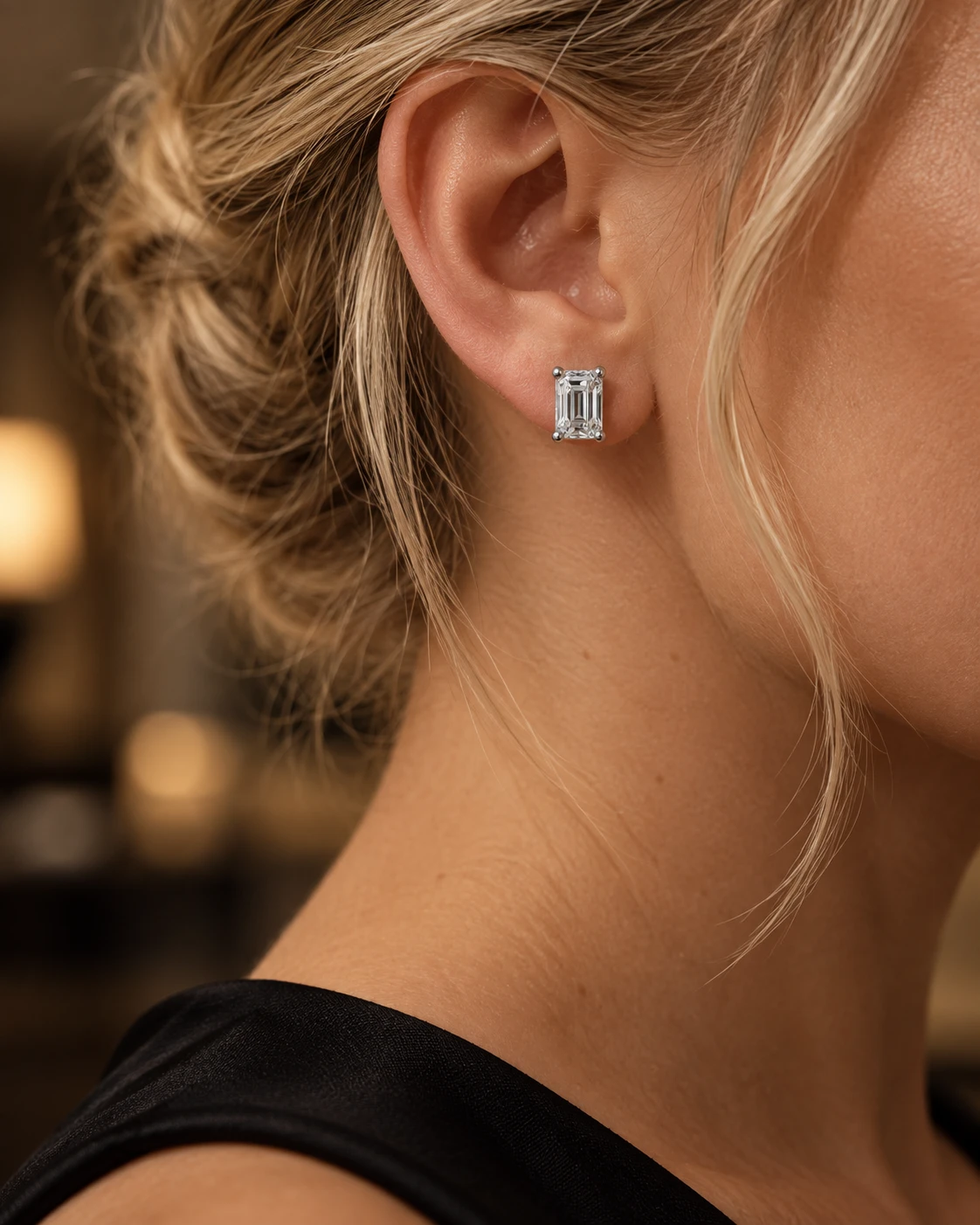 Illustrative close-up of emerald-cut diamond stud earrings, after hours styling