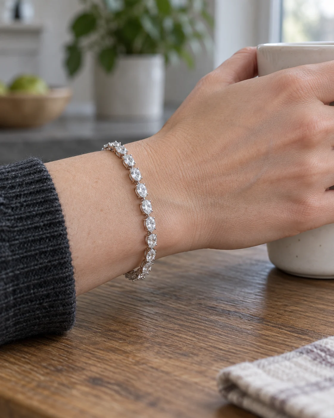 Illustrative side view of bracelet on a wrist holding a coffee cup